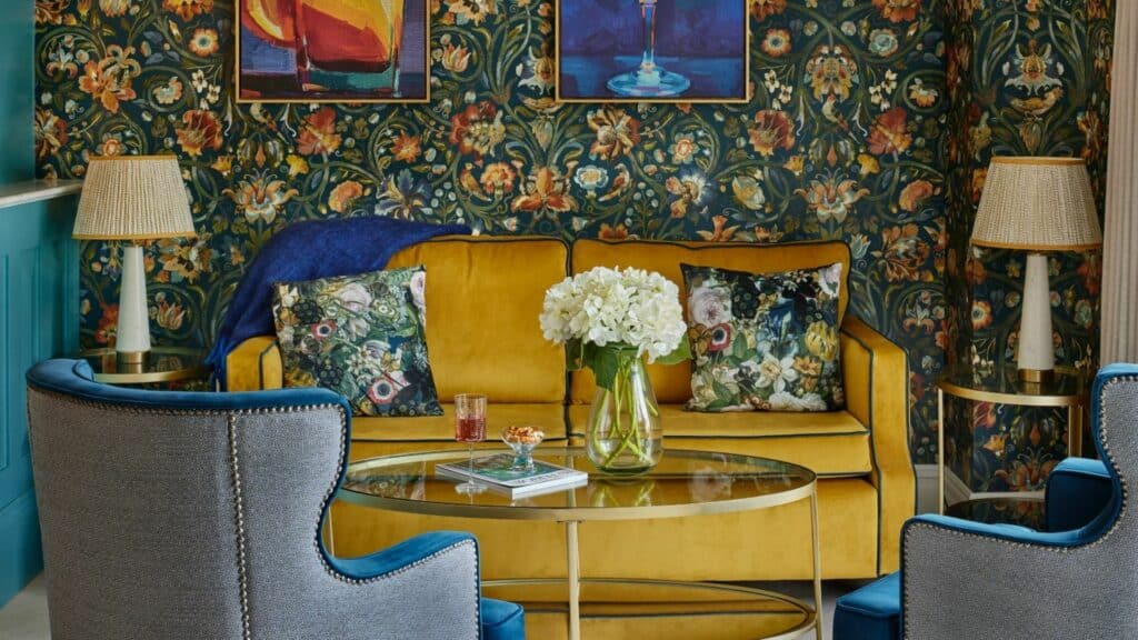 Floral-themed living room with yellow sofa and blue chairs