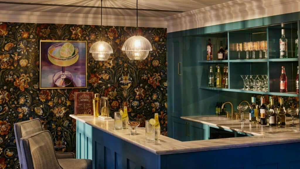 Elegant home bar with floral wallpaper in our care home in Bath.