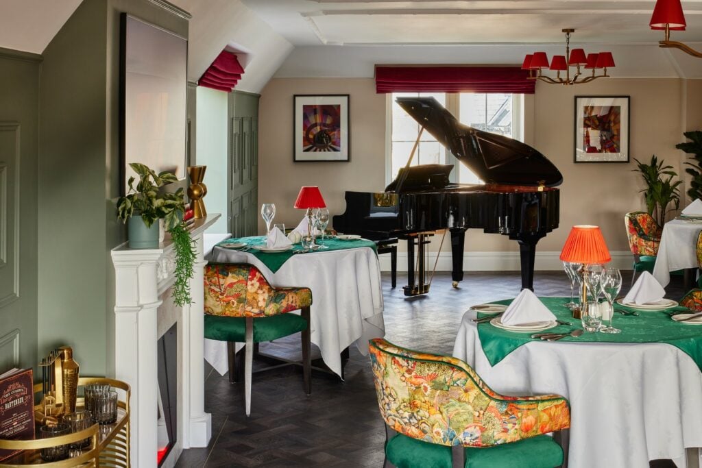 Elegant restaurant with a grand piano and vibrant décor.
