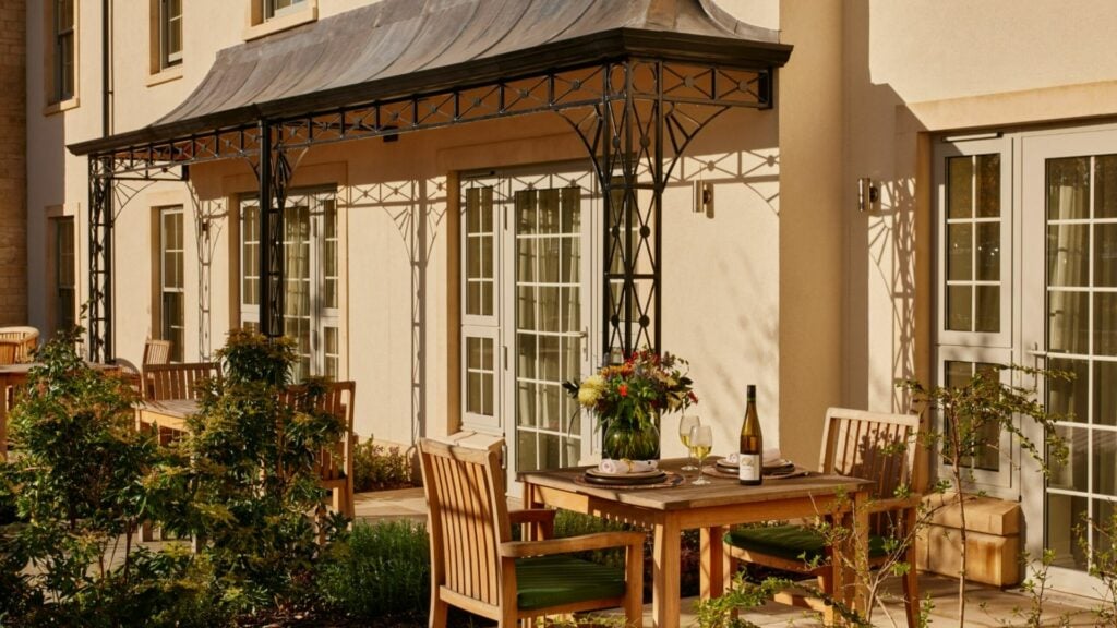 Outdoor patio with tables, chairs, and flowers
