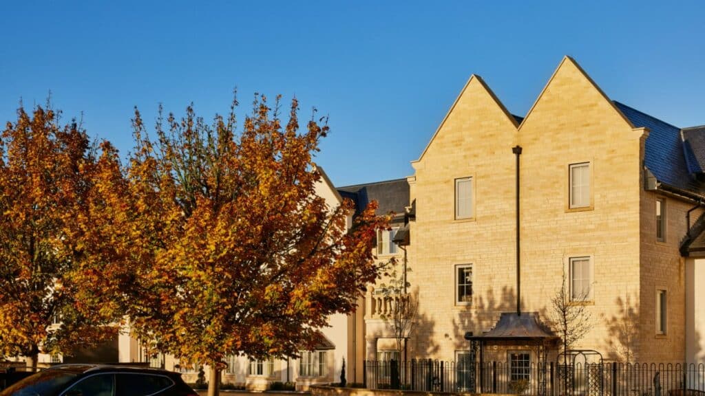 Autumn trees in front of stone building
