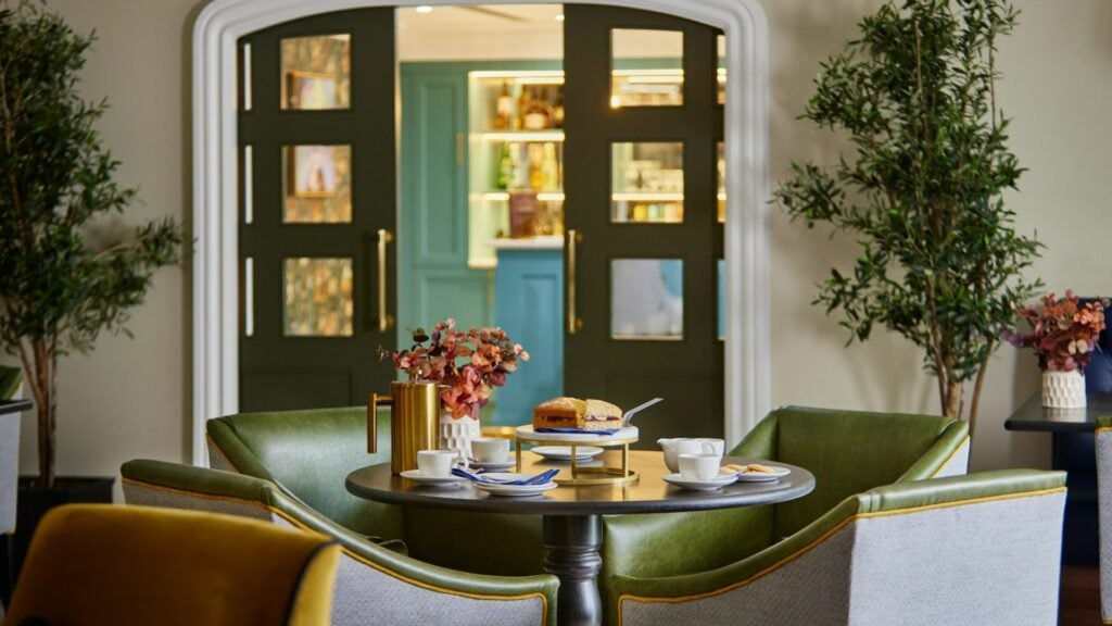 Cosy tearoom with scones and teacups on the table.