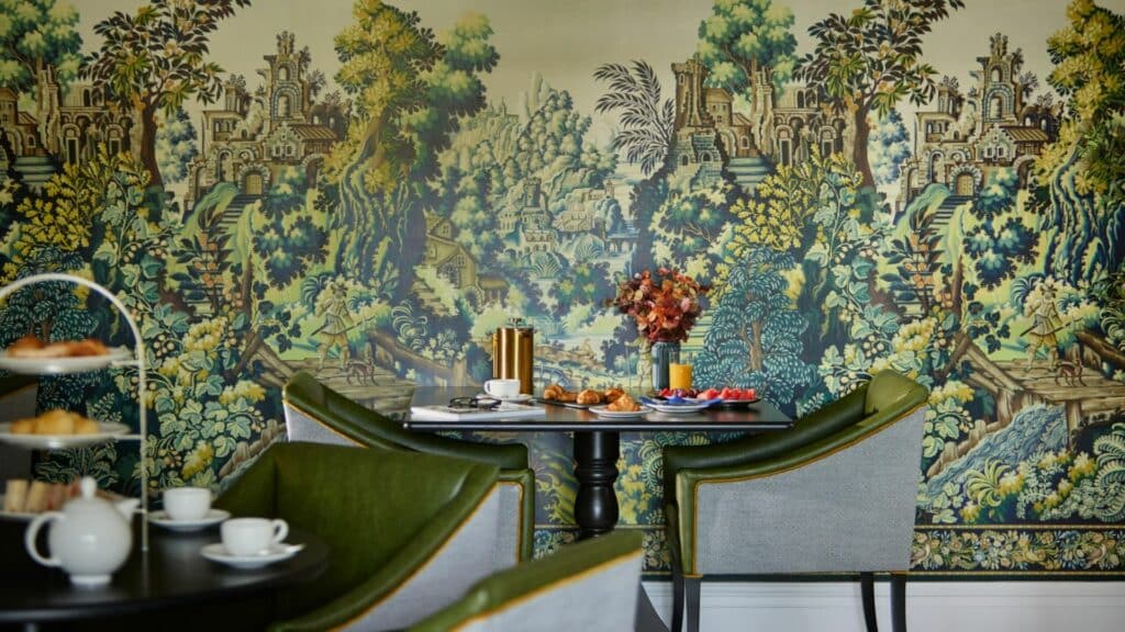 Elegant cafe with vibrant mural and pastries.
