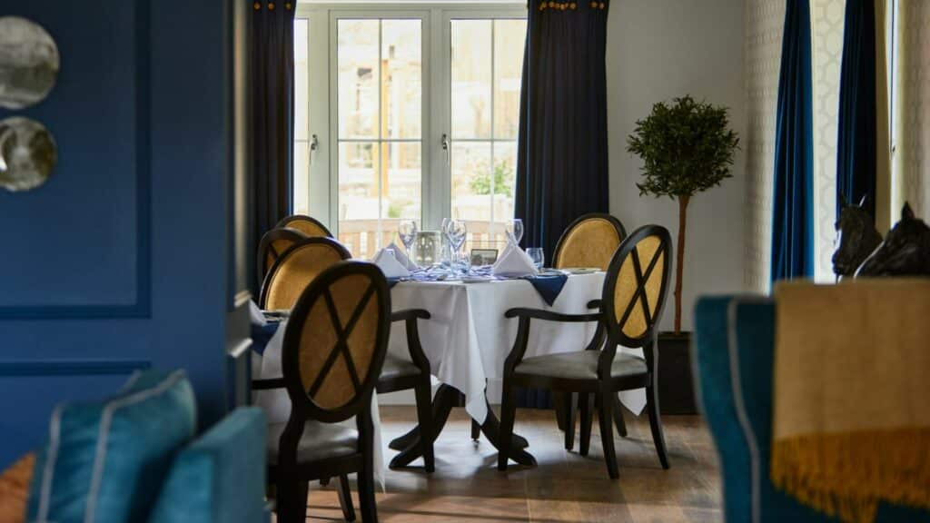 Elegant dining room with round table setting.