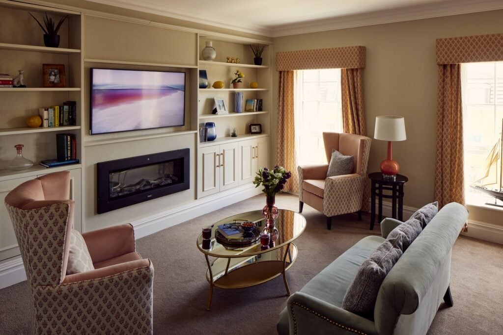 Cosy living room with TV, fireplace, and seating.