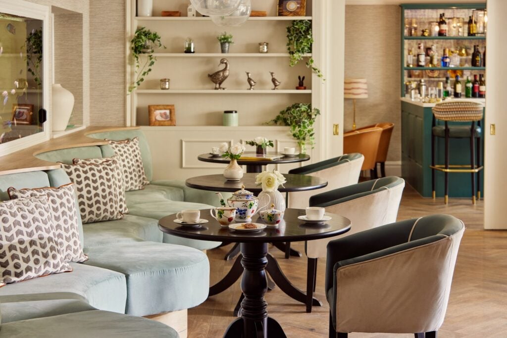 Cozy tea room with elegant decor and seating.
