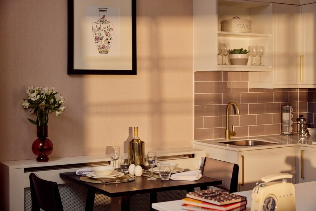 Cosy kitchen with dining table setup at sunset.