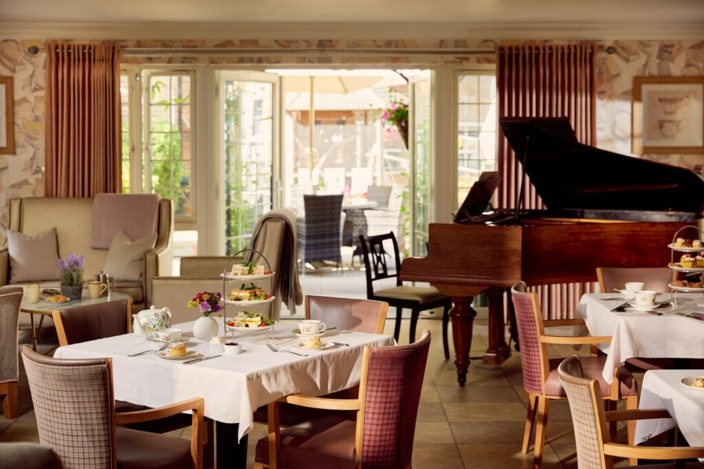 Elegant restaurant afternoon tea setup with grand piano.