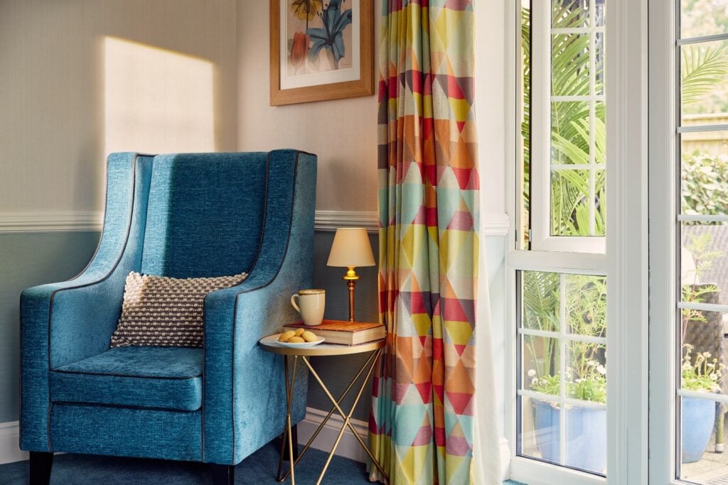 Cosy reading nook with armchair and table.
