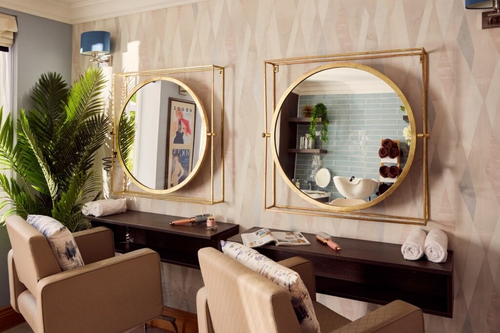 Modern hair salon with mirrors and styling chairs.