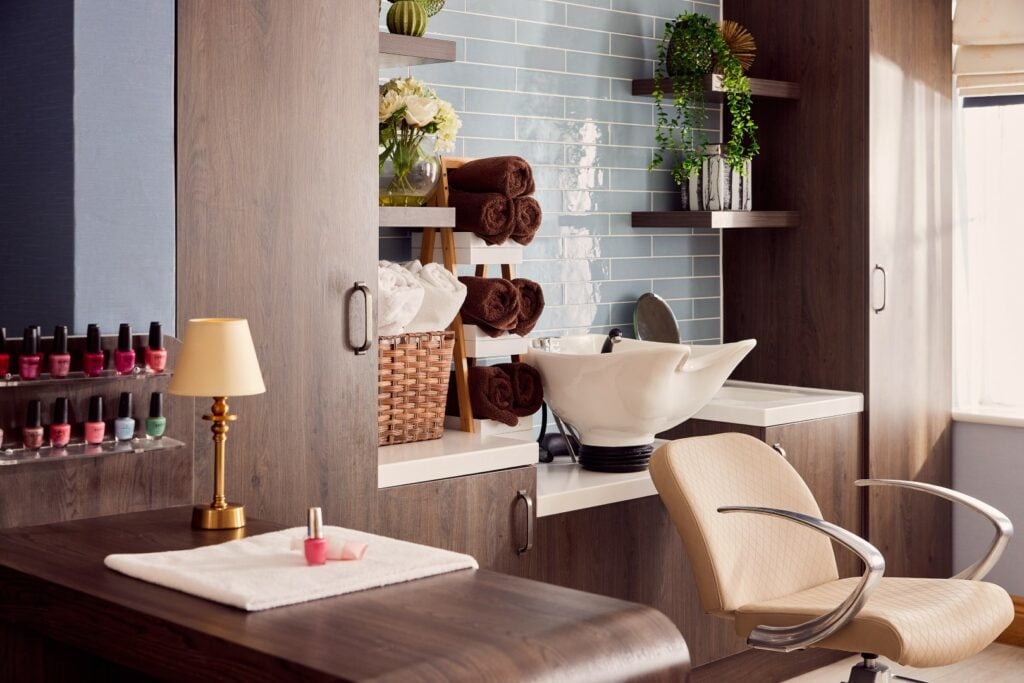 Modern beauty salon with nail polishes and sink.