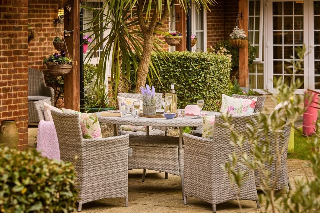 Cosy garden patio with rattan furniture and decor
