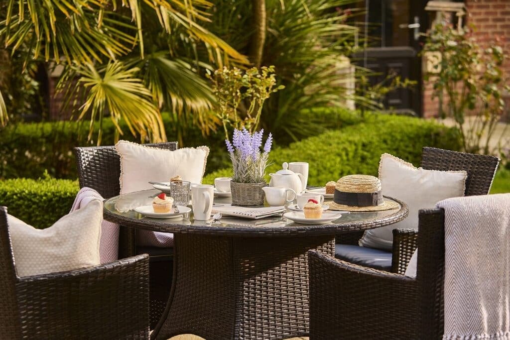 Outdoor table setting with tea and cupcakes