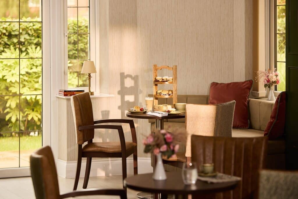 Cosy cafe with afternoon tea setup by window.