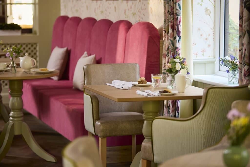 Elegant café interior with vibrant pink seating.