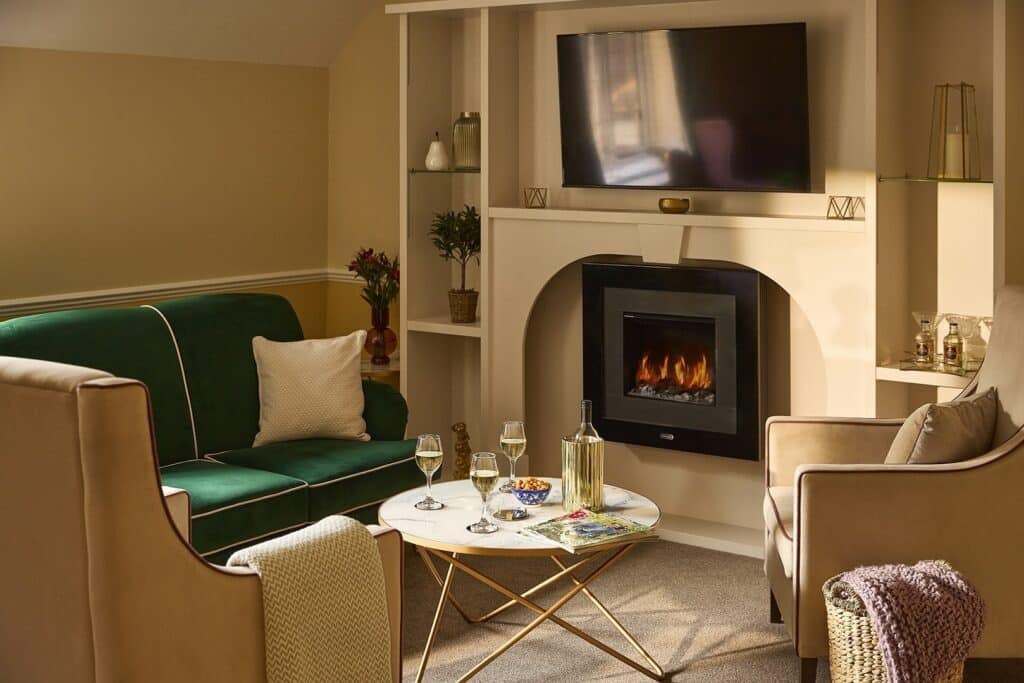 Cozy living room with fireplace and green sofa.