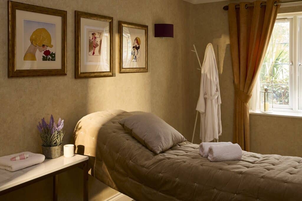Cosy spa room with massage bed and decor.