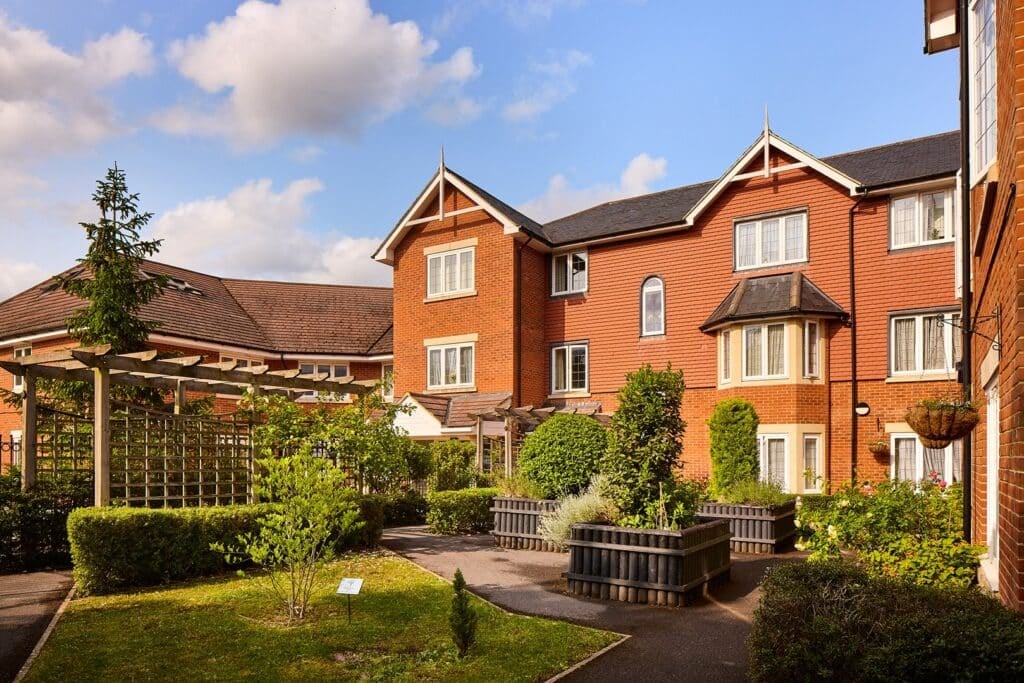 Elegant brick building with lush garden view