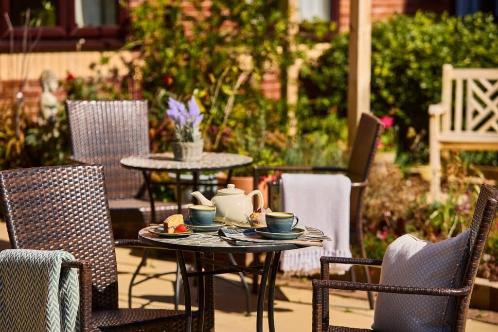 Outdoor table with tea and scones in garden