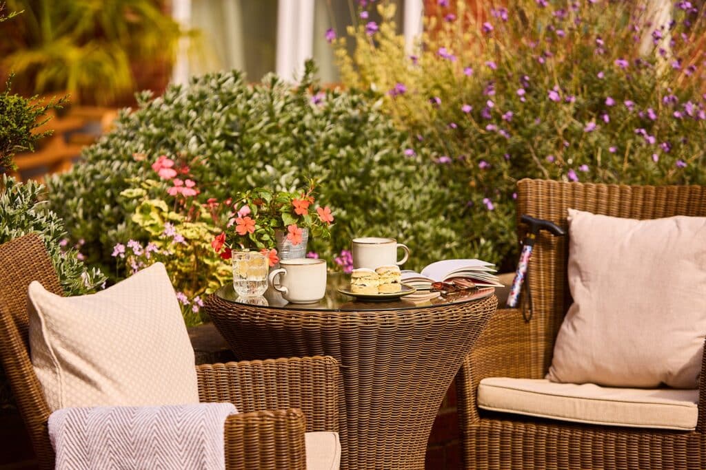 Outdoor wicker table with tea and scones