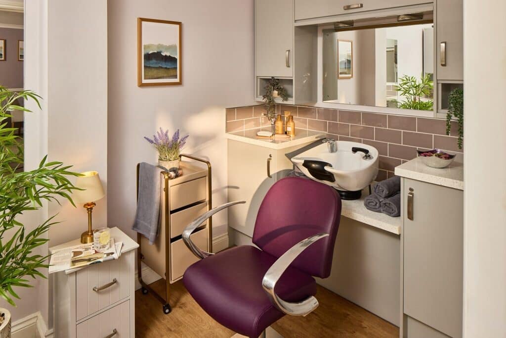 Modern hair salon with purple chair and sink