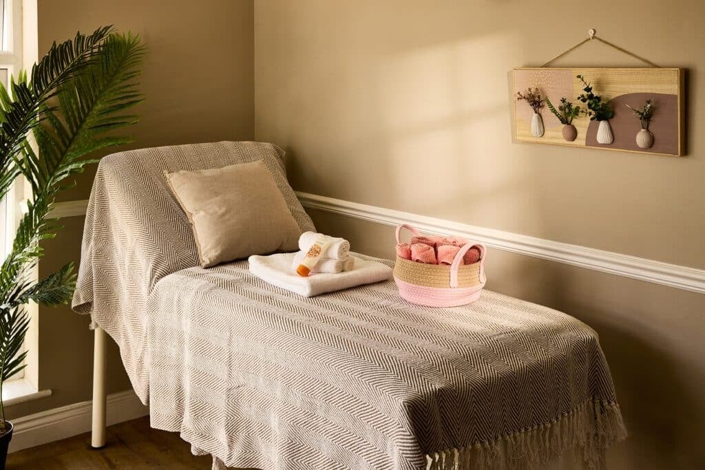 Relaxing spa room with massage bed and towels