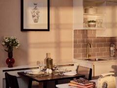 Cosy kitchen with dining table setup at sunset.