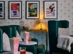 Cosy home cinema with popcorn and classic movie posters.