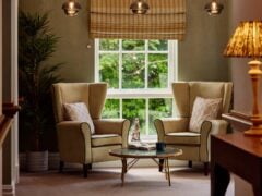 Cosy sitting area with armchairs and coffee table.