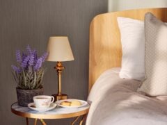 Cosy bed with tea, biscuits, and flowers