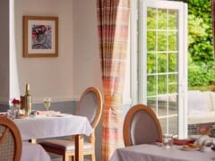 Cosy restaurant interior with open door