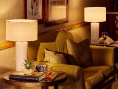 Cosy living room with lamps and armchair.