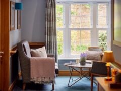Cosy lounge area with chairs and window view.