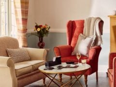 Cosy living room with beige and red chairs