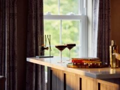 Cocktails on home bar near window.