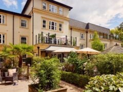 Luxury retirement village with gardens and seating.
