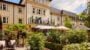Luxury retirement village with gardens and seating.