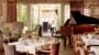 Elegant restaurant afternoon tea setup with grand piano.