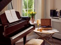 Grand piano with sheet music and vintage record player