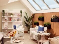 Bright cosy reading nook with plants and comfy seats.