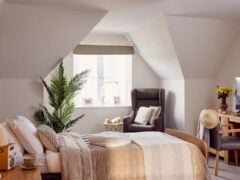 Cosy bedroom with modern furniture and decor.