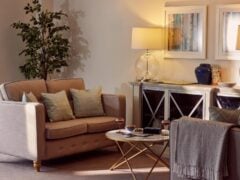 Cosy living room with sofa, lamps, and coffee table.