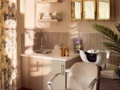 Modern salon wash station with sink and floral decor.
