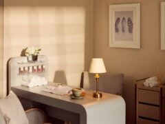 Cosy salon with manicure setup, lamp, and coffee.