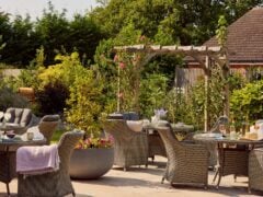 Beautiful garden patio with wicker furniture and plants at our care home in Banstead.