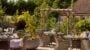 Beautiful garden patio with wicker furniture and plants at our care home in Banstead.