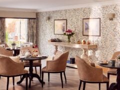 Cosy café with elegant decor and seating arrangement.