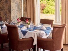 Elegant dining table set with flowers and napkins