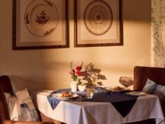 Cosy table for two with flowers in the dining room of Banstead Manor Care Home.