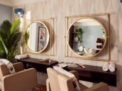 Modern hair salon with mirrors and styling chairs.